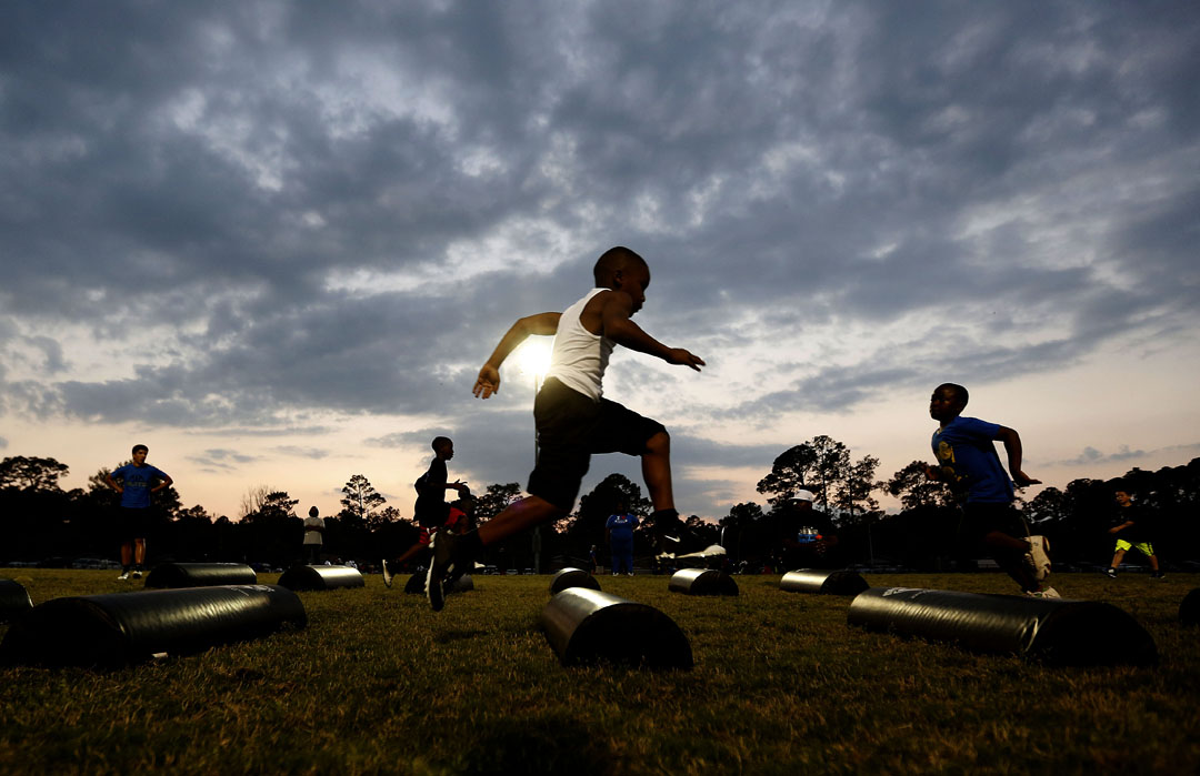 A players runs a drill during Youth Friday Night Lights at Cone Park on Friday, March 20, 2015 in Gainesville, Fla. The Gainesville Panthers youth football program hosted the event that gave players aged 4-14 to run drills and learn football basics. Members of the Elite Athletics helped coach and played a 7 on 7 scrimmage. (Matt Stamey/Staff photographer)