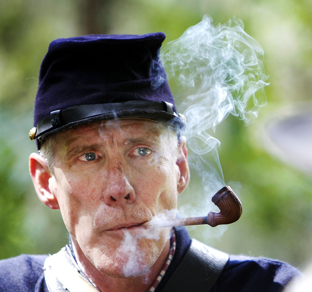 Keith VanLeuven smokes a pipe after the reenactment of the Civil War's Battle of Gainesville on Saturday, August 15, 2015 in Gainesville, Fla. The battle took place on August 17, 1864 in downtown Gainesville. Confederate forces, led by Capt. J.J. Dickison, a.k.a. "Swamp Fox, defeated the Union army, led by Col. Andrew L. Harris. (Matt Stamey/Staff photographer)