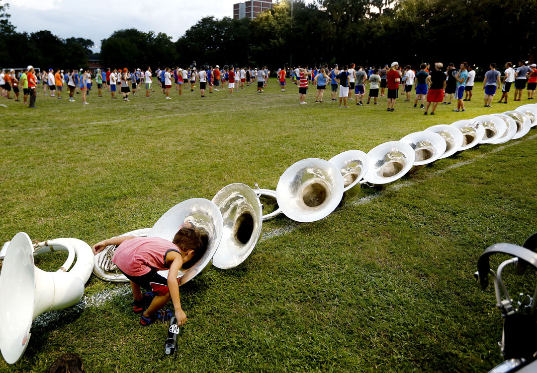 Taiko Keck, 5, shouts into the bell of a sousaphone during camp for the University of Florida Marching Band on Thursday, August 20, 2015 in Gainesville, Fla. The band started its camp this week and it runs from 8 a.m. to 9:30 p.m. every day with outdoor marching sessions, indoor music sessions and meal breaks. (Matt Stamey/Staff photographer)