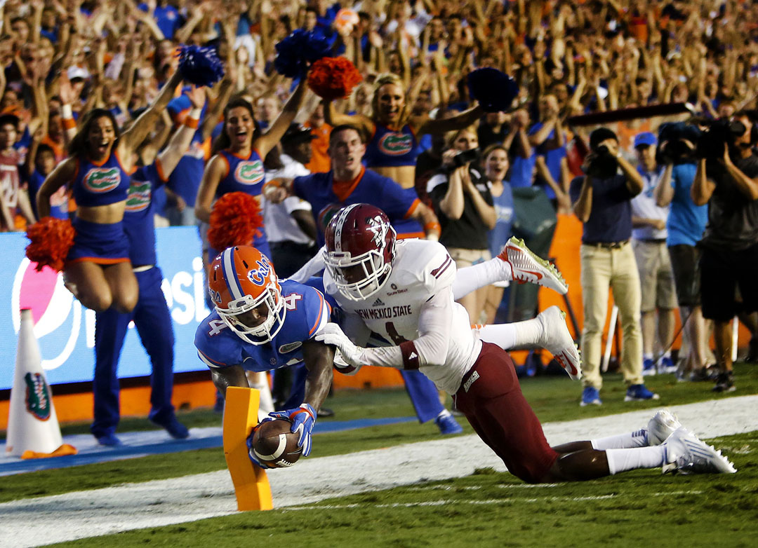 Florida Gators wide receiver Brandon Powell (4) dives for a touchdown past New Mexico State Aggies defensive back Winston Rose (4) during the first half on Saturday, Sept. 5, 2015 in Gainesville, Fla. (Matt Stamey/Staff photographer)