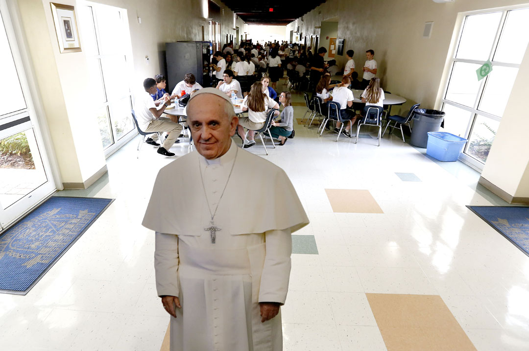A cardboard cutout of Pope Francis in the hallway as students eat lunch after Mass at St. Francis Catholic High on Tuesday, Sept. 22, 2015 in Gainesville, Fla. The school hosted students from area Catholic schools for a Mass and lunch to celebrate the arrival of Pope Francis to the United States. (Matt Stamey/Staff photographer)