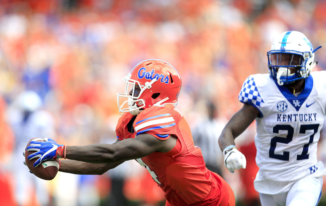 Florida Gators wide receiver Brandon Powell (4) hauls in a pass in front of Kentucky Wildcats safety Mike Edwards (27) during the first half at Steve Spurrier Florida Field at Ben Hill Griffin Stadium on Saturday, Sept. 10, 2016 in Gainesville, FL. After review, it was determined that the ball hit the ground as he fell and was ruled incomplete. Florida defeated Kentucky 45-7. Matt Stamey/Gainesville Sun