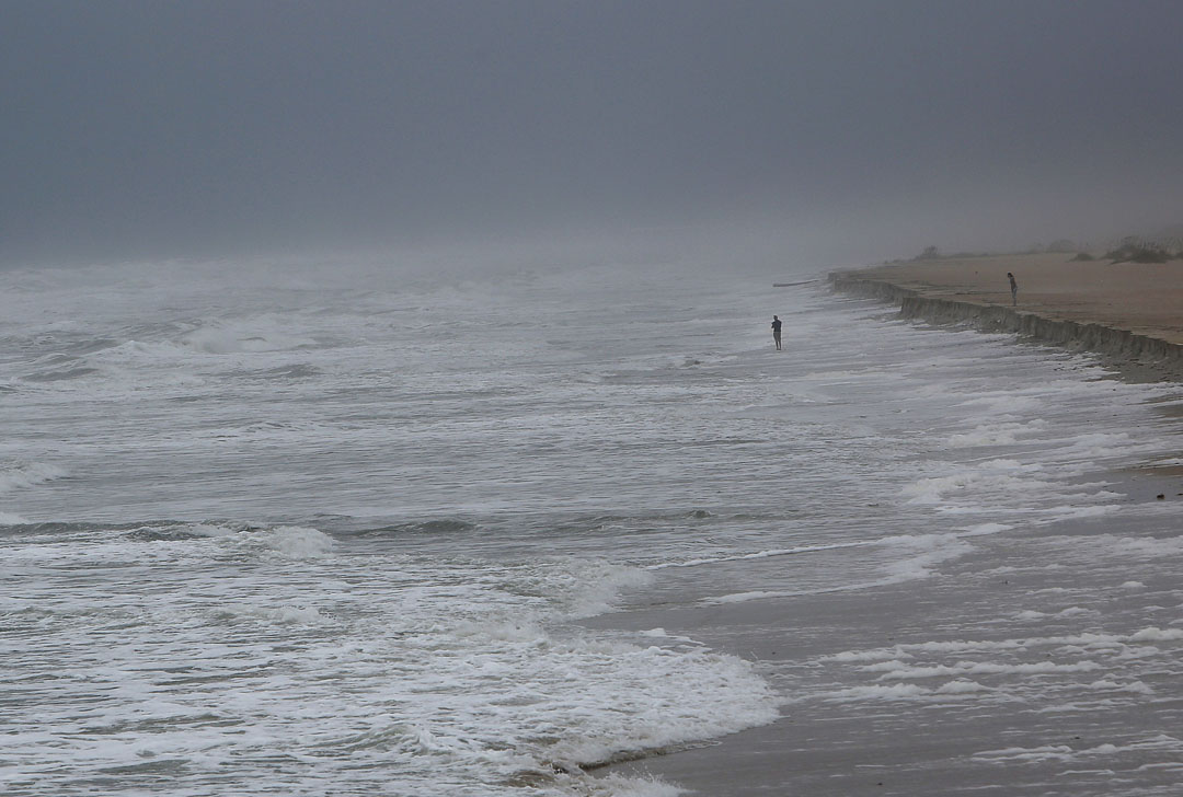 A mans stands in the surf as Hurricane Matthew approaches on Thursday, Oct. 6, 2016 in St. Augustine, FL. Matt Stamey/Gainesville Sun