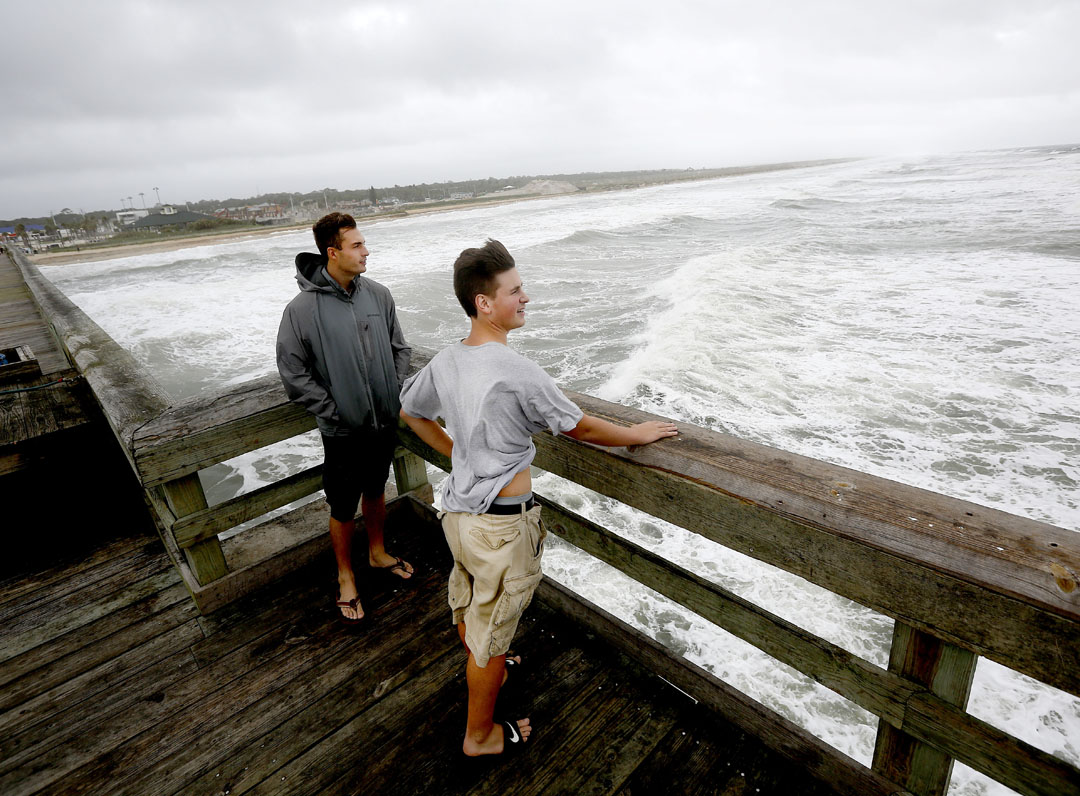 Flagler College students Corey Wademan, left, and Joe Mostler stand at the end of the pier to watch the waves as Hurricane Matthew approaches on Thursday, Oct. 6, 2016 in St. Augustine, FL. Matt Stamey/Gainesville Sun