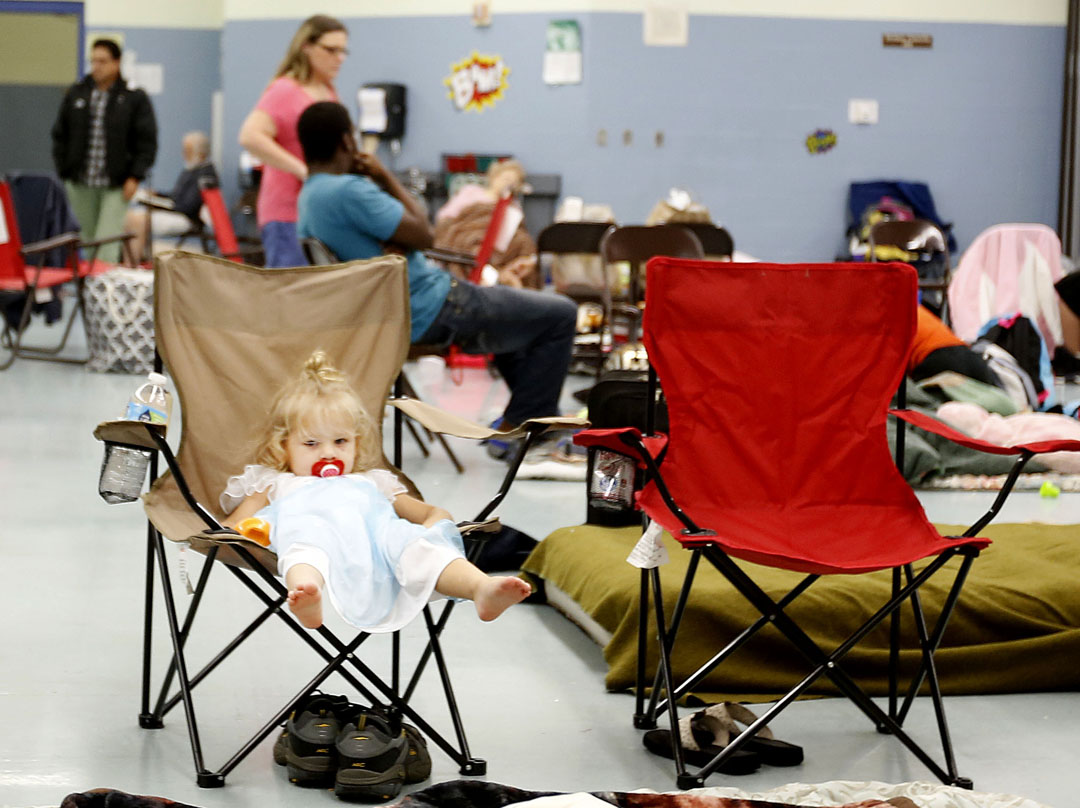 June Meeker, 2, sits in a chair after evacuating to Mason Elementary as Hurricane Matthew approaches on Thursday, Oct. 6, 2016 in St. Augustine, FL. The school's cafeteria doubled as a storm shelter. Matt Stamey/Gainesville Sun