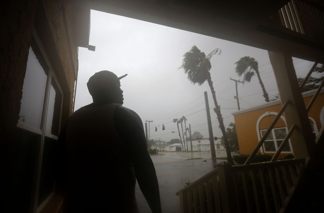 A man who identified himself as J.J. watches the wind and rain from the front door of his apartment during Hurricane Matthew on Thursday, Oct. 6, 2016 in St. Augustine, FL. Matt Stamey/Gainesville Sun