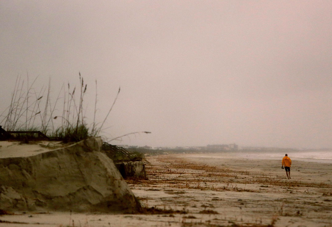 A man walks along Crescent Beach during Hurricane Matthew on Thursday, Oct. 6, 2016 in St. Augustine, FL. Matt Stamey/Gainesville Sun