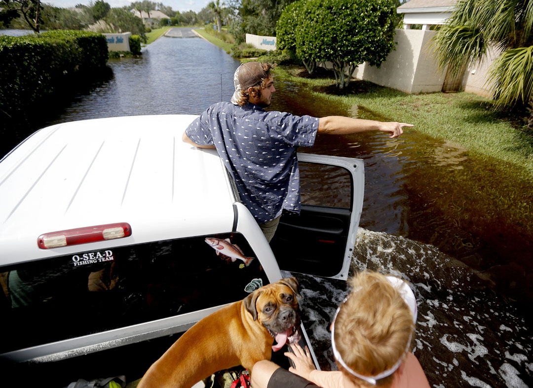 Kyler Williams points while riding through flooded streets of the Seagate neighborhood while driving around to see damage on the island after Hurricane Matthew on Friday, Oct. 8, 2016 in St. Augustine, FL. Matt Stamey/Gainesville Sun