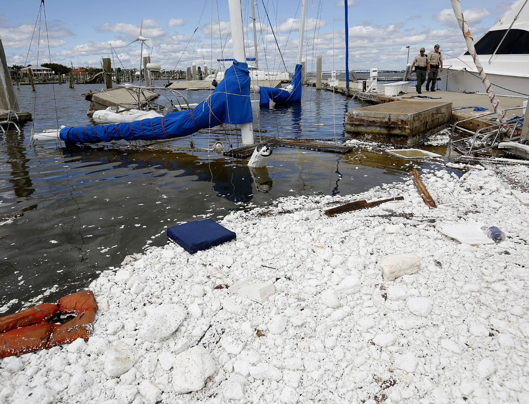 Florida Fish and Wildlife officials walk past two sunken boats at the Conch Marina after Hurricane Matthew on Friday, Oct. 8, 2016 in St. Augustine, FL. Matt Stamey/Gainesville Sun