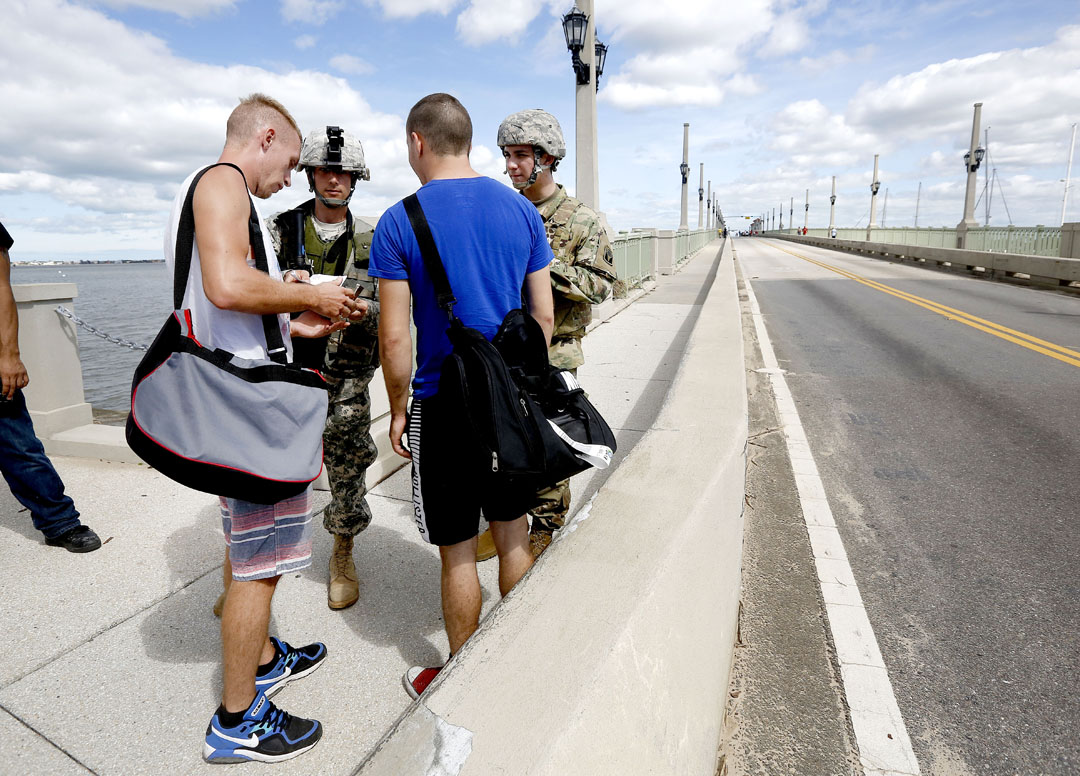 Florida National Guard members check identification at the base of the Bridge of Lions after Hurricane Matthew on Friday, Oct. 8, 2016 in St. Augustine, FL. Only residents of the island were able to walk across. Vehicle traffic was not allowed to cross. Matt Stamey/Gainesville Sun