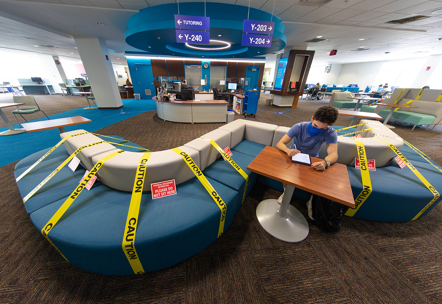 A student studies at the one area of the couch allowed due to social distancing guidelines in the library during the second day of classes at Santa Fe College on Aug. 25, 2020 (Matt Stamey/Santa Fe College ) ***Subjects Have Releases***