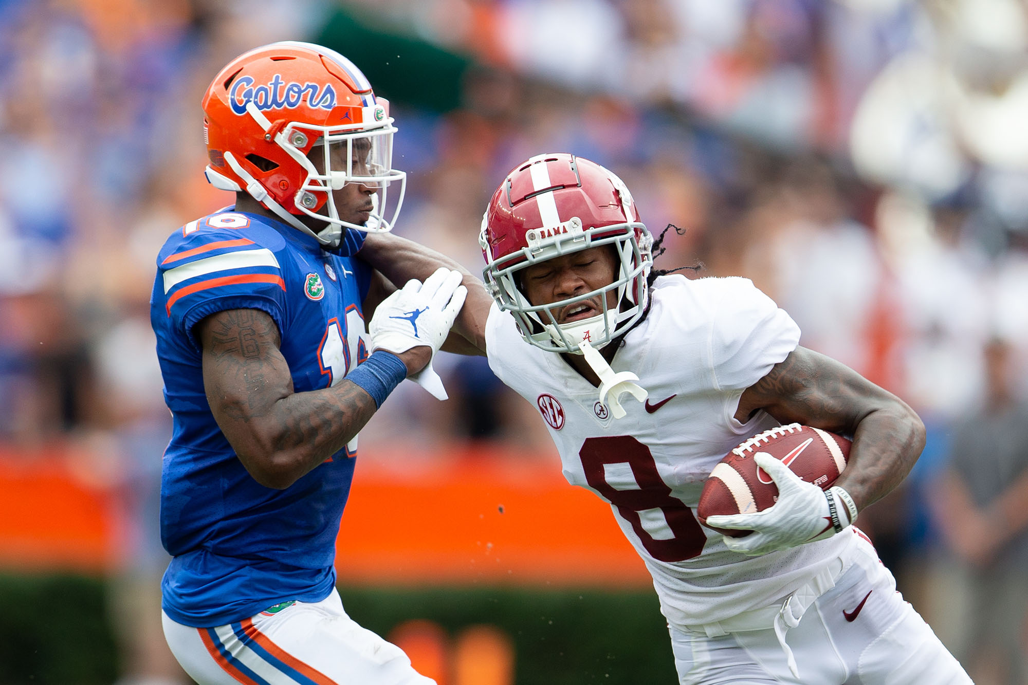 Alabama Crimson Tide wide receiver John Metchie III (8) stiff arms Florida Gators safety Tre'Vez Johnson (16) during an NCAA college football game Saturday, Sept. 28, 2021, in Gainesville, Fla. Alabama defeated Florida 31-29. (Matt Stamey via AP)