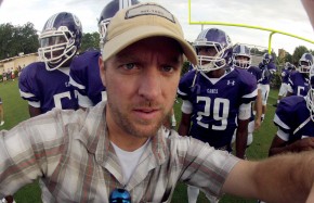Setting up a helmet cam on a high school football player. 
